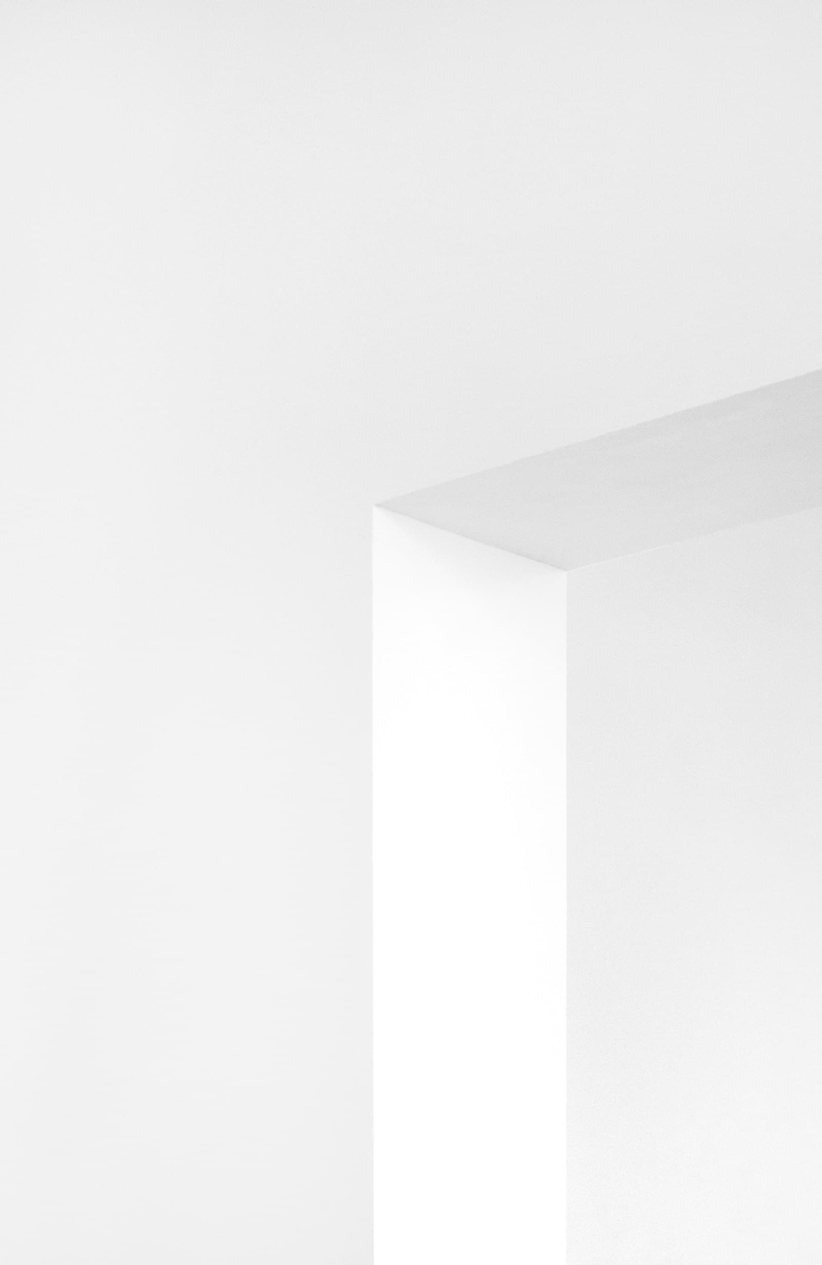 A carved white architectural arch in raking light