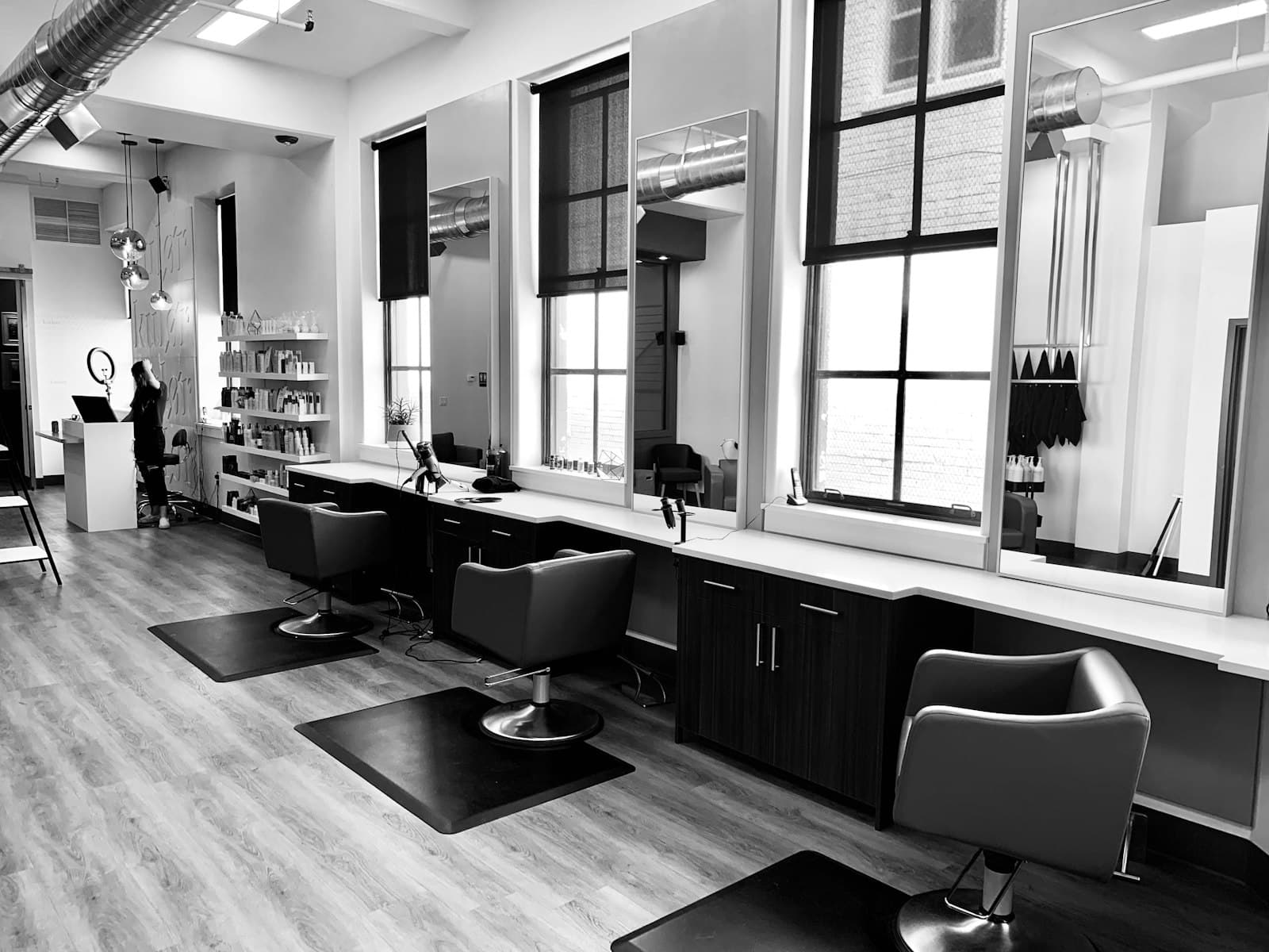 The MARMO studio in monochrome: tall windows, empty chairs, morning light